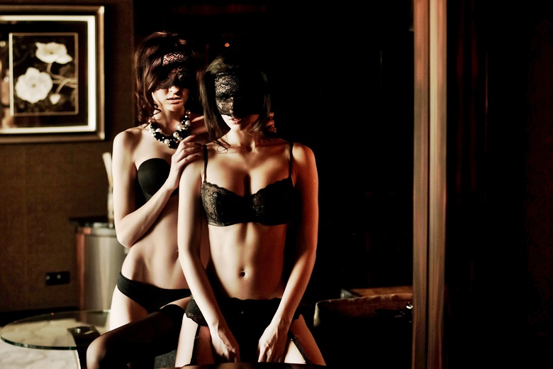Two womans in black underwear.